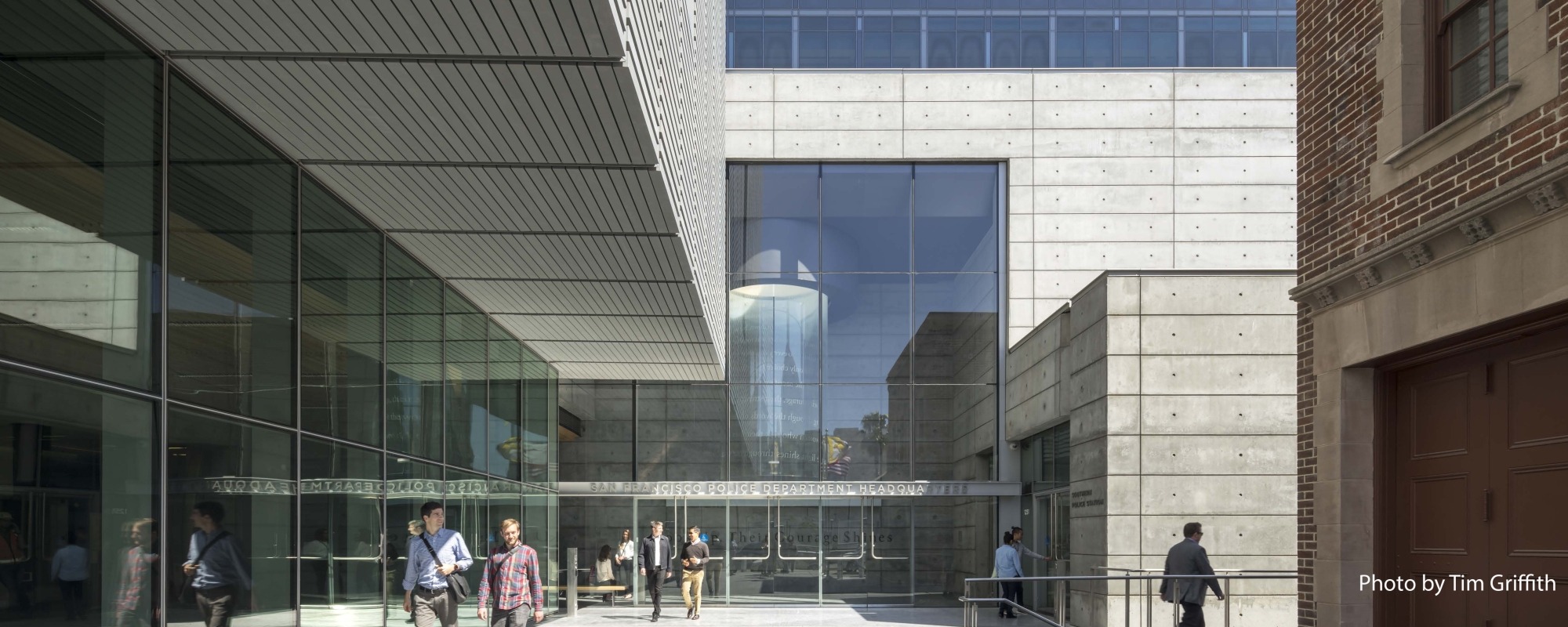 People walk past the San Francisco Public Safety Building. 